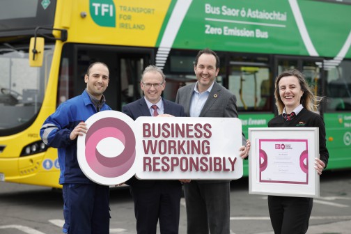 Mechanic Ahmed Daido and Driver Ana Maria Bobaila are standing with Bus Éireann CEO Stephen Kent and Business in the Community CEO Tomás Sercovich and standing in front of a grenn and yellow Zero Emission Hydrogen bus holding the Business working responsibly certification  