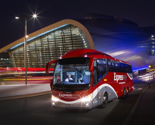 Image of a Bus Éireann Expressway coach exiting Dublin Airport at night